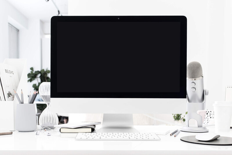 desktop computer with pencil holder, keyboard, podcast microphone and mouse