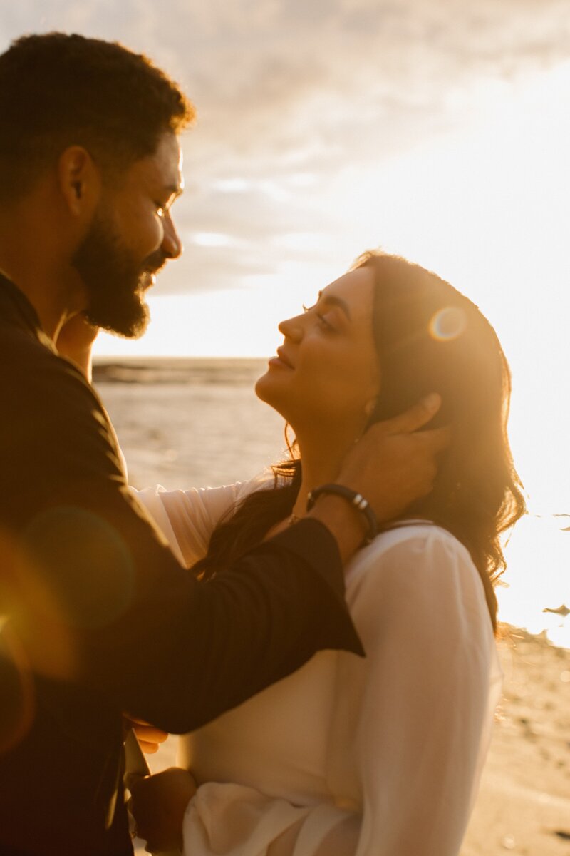 bride and groom looking at each other on beach in hawaii