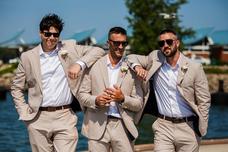 Groom and his groomsmen pose for a photo on Erie, PA's Dobbins Landing