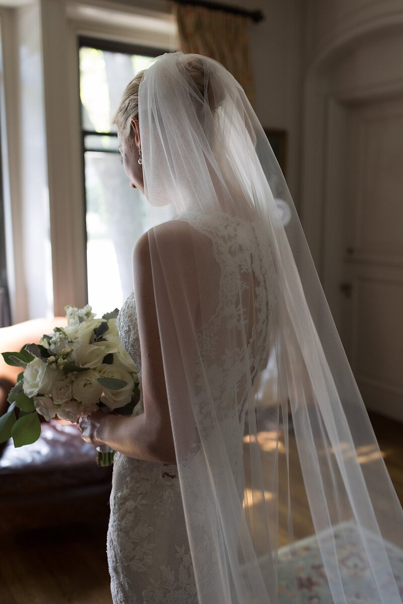 View of back of bride's wedding dress with veil. Deborah Zoe Photography.