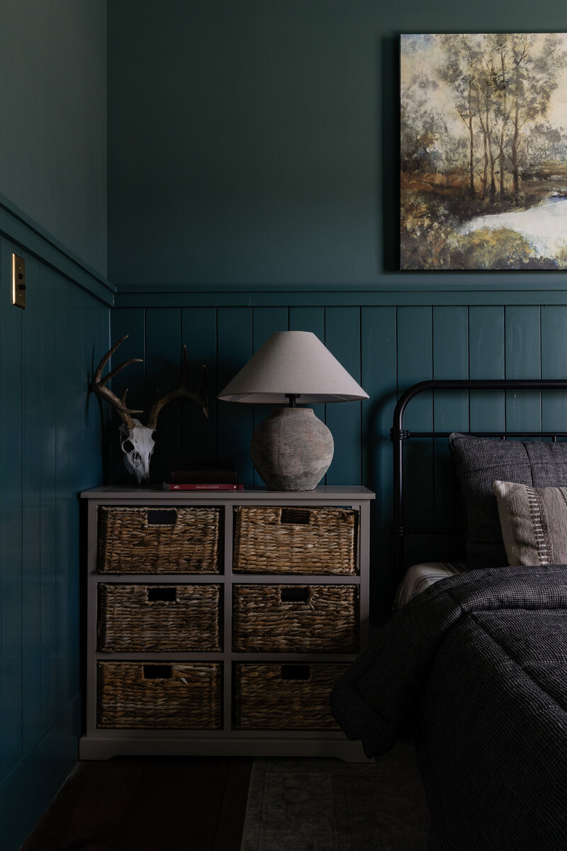 This teenage boy's bedroom is drenched in a dark, forest green, styled with textured elements for masculinity while keeping the feel of the room classic. By Jessa Myer Interiors.