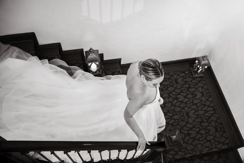 Bride looking out the window in wedding dress