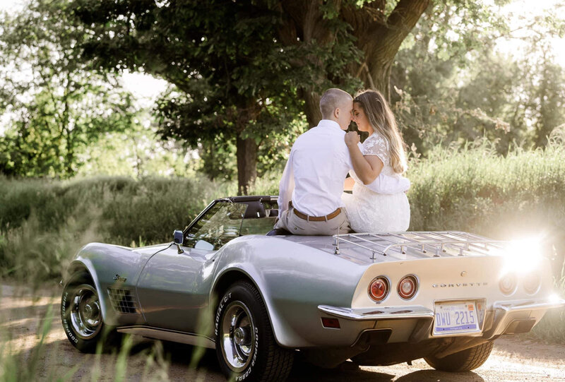 a newly engaged couple with a vintage car at sunset by Kelly Jo Photography