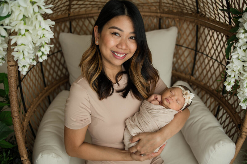 New mom snuggling her newborn baby sleeping