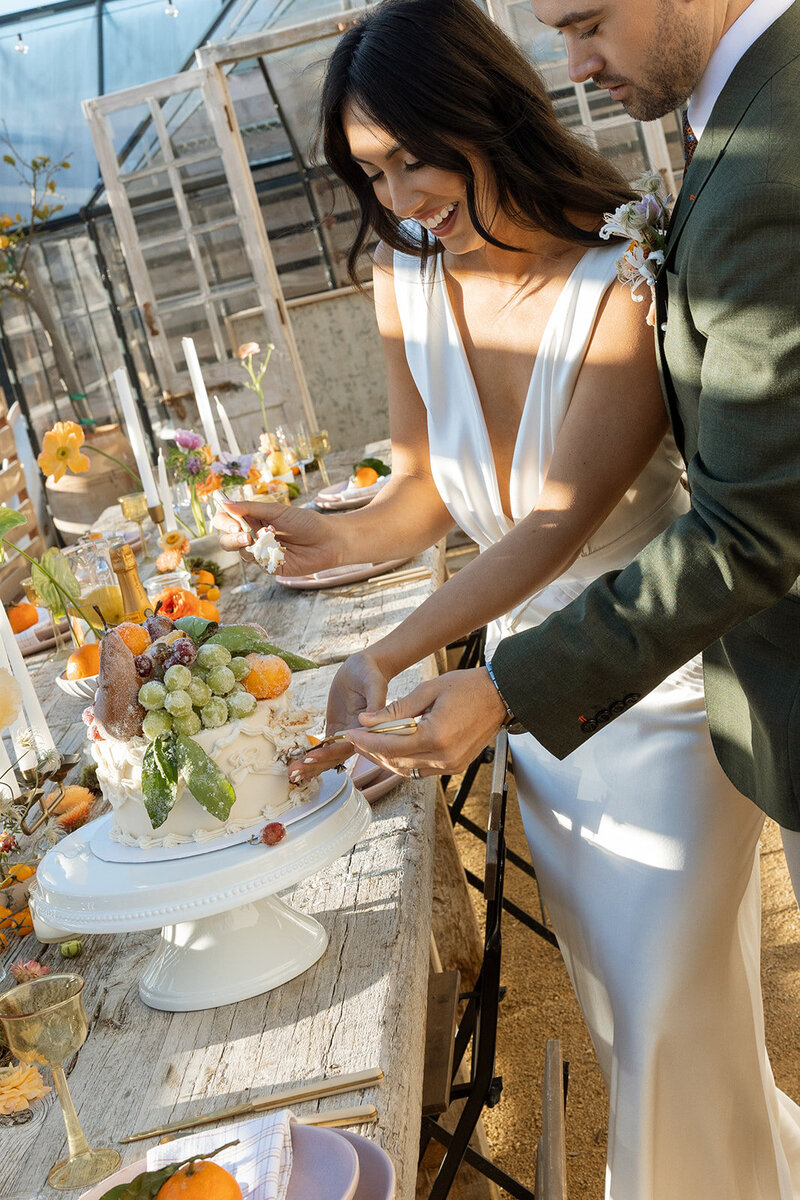 couple cutting the cake during an intimate wedding in Orange County