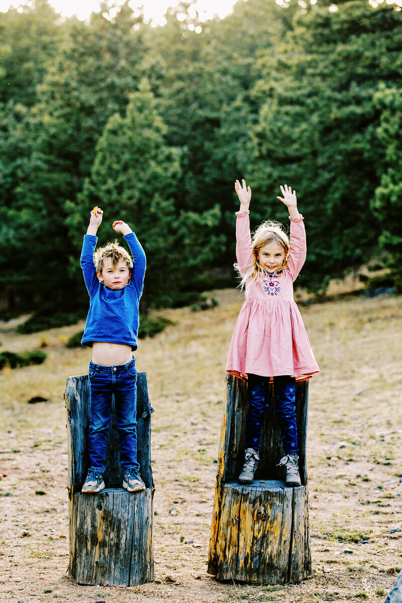 kids stand on log chairs in nederland colorado