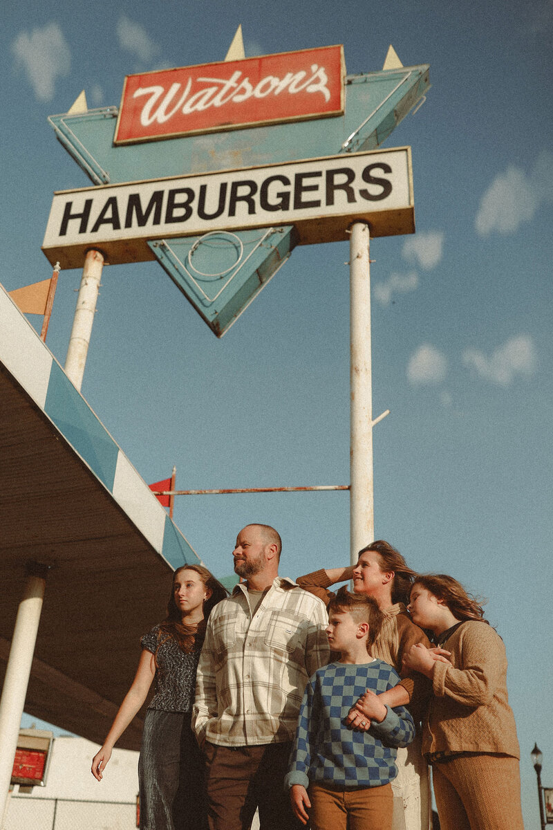 Photographer Melanie Dalton with her family in front of a retro burger joint.