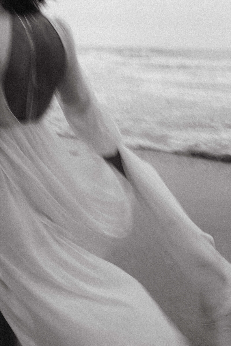 blur photo of bride running on the beach