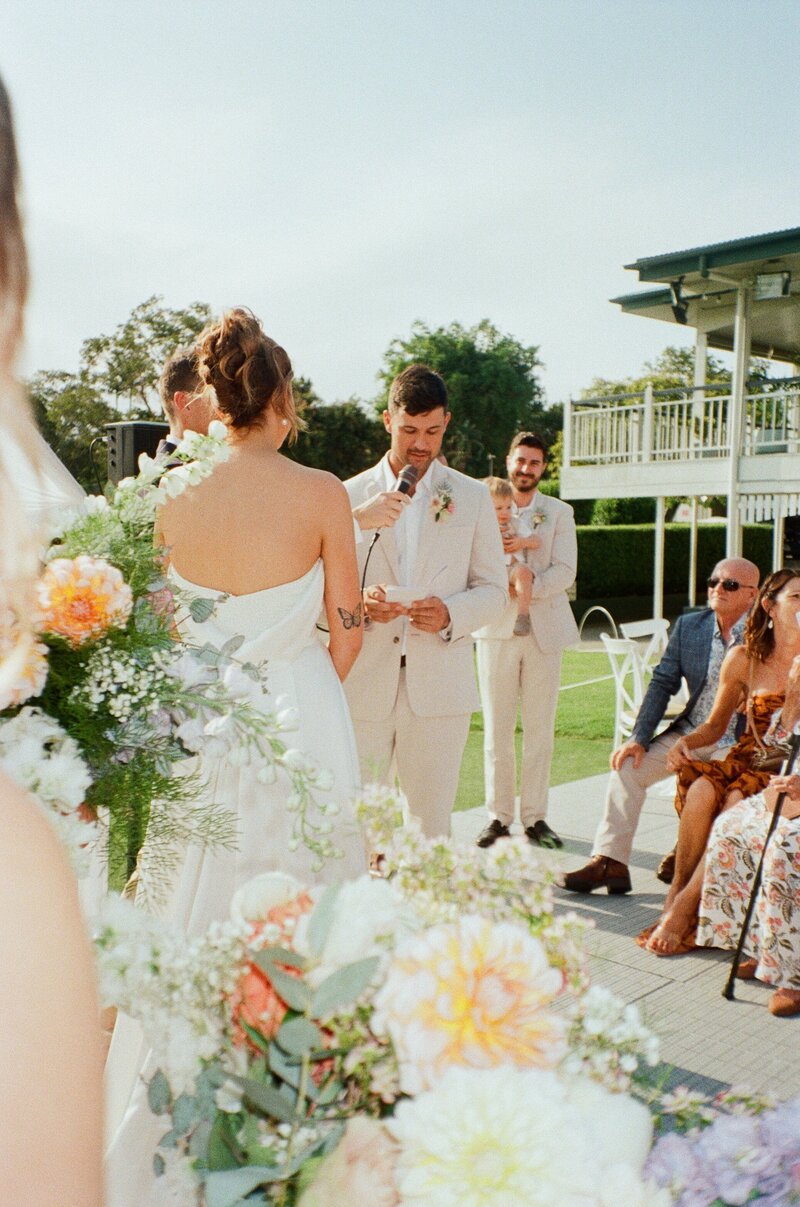 A couple photographed on film saying their vows at the Wynnum Golf Club