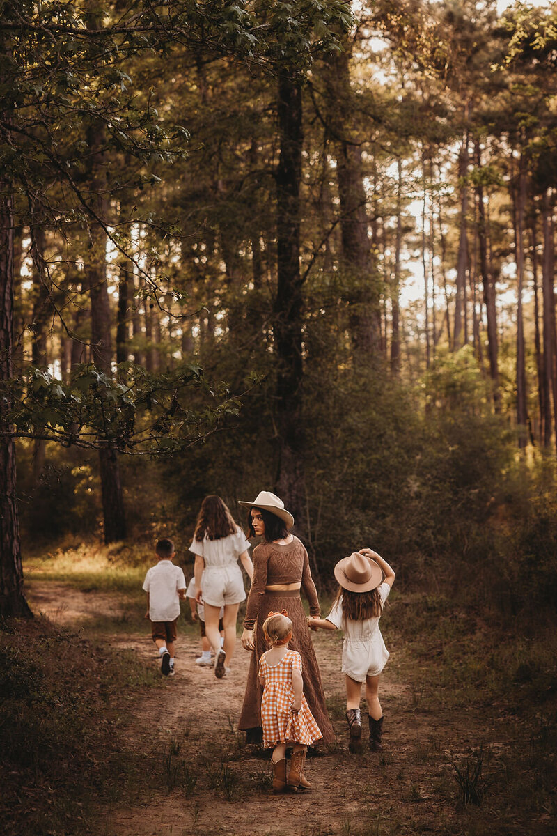 Family of five walking through the woods in The Woodlands, Texas.