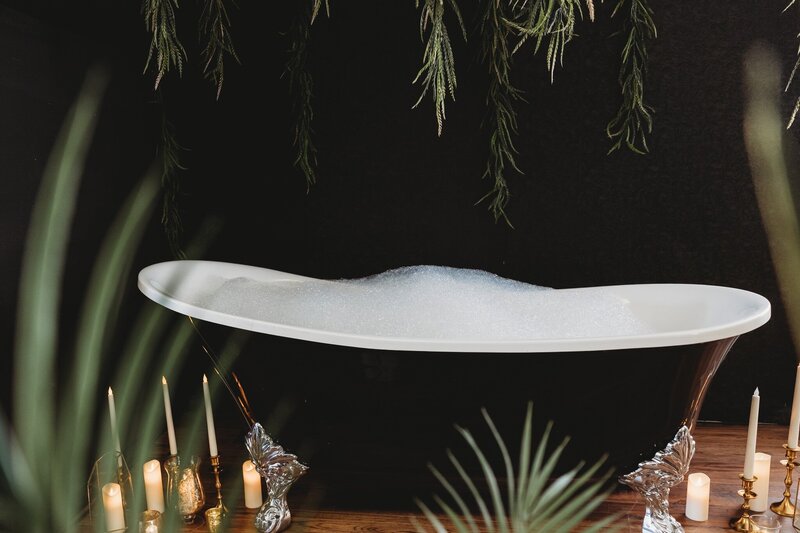 bathtub with bubbles and plants