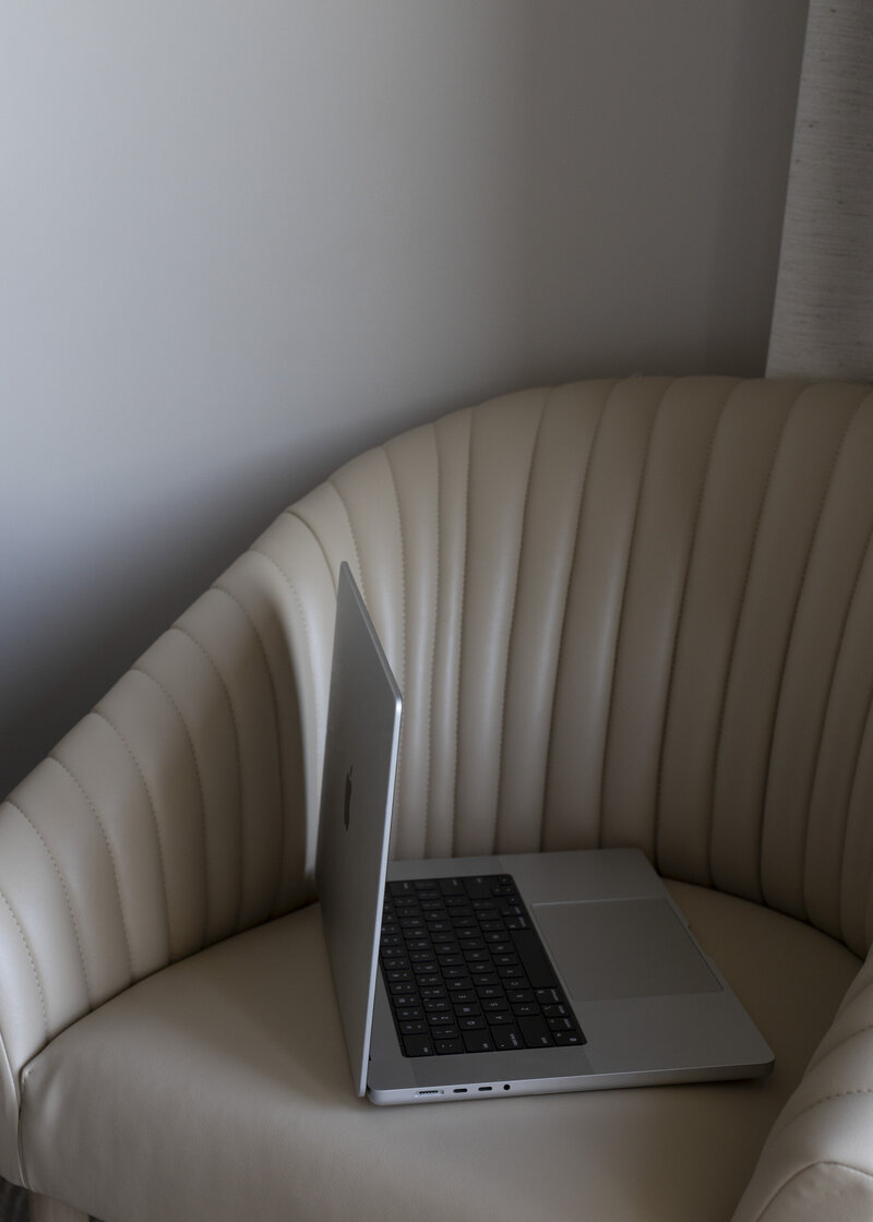 Image of a laptop on a chair on a website for therapy intensives for moms of color in Massachusetts and Texas