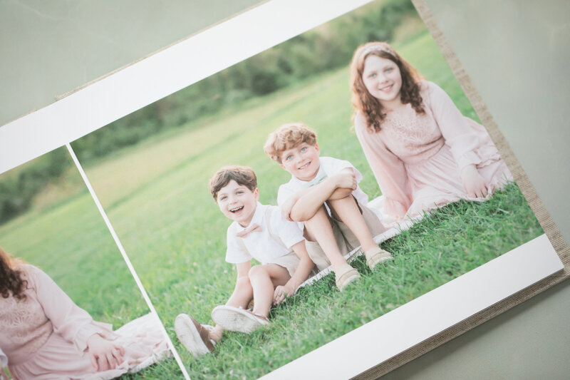 linen album with 3 children smiling in photo