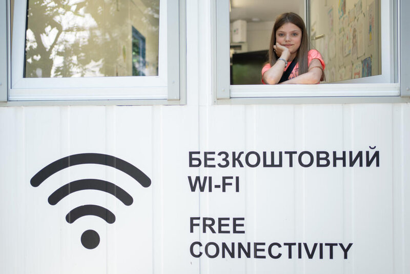 Ukrainian refugee girl in portable connectivity center