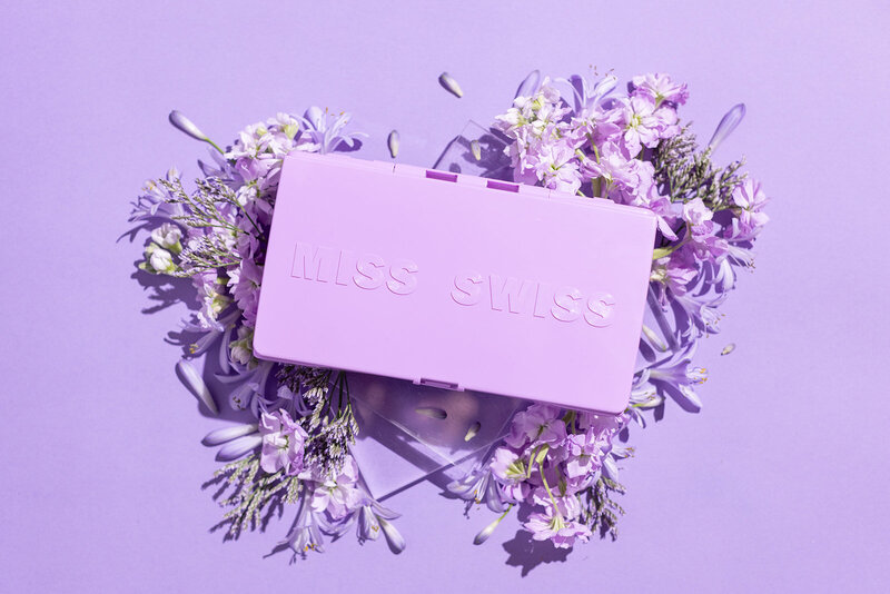 Miss Swiss brand photo taken by Love Social Media - purple box surrounded by purple flowers