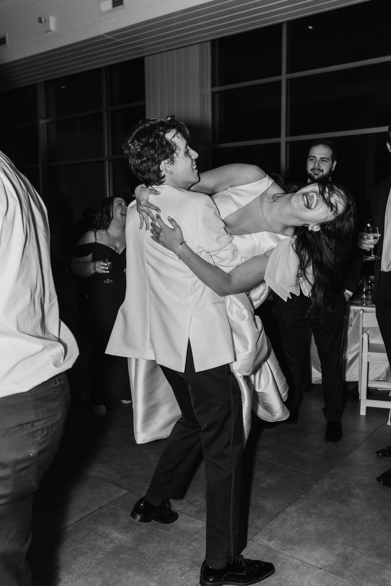 Black and white photo of bride and groom dancing on the dance floor at their wedding | Emma Leeann Photography