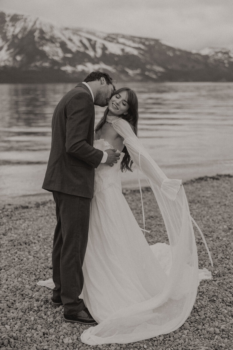 Couple taking elopement photos at Colter Bay in Jackson Hole, Wyoming
