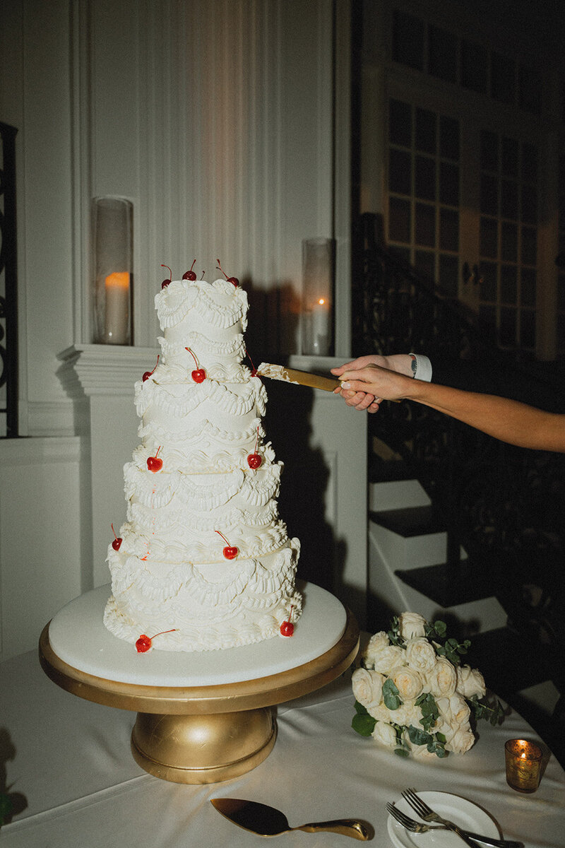 couple cuts cake at cescaphe ballroom during wedding in philly pa