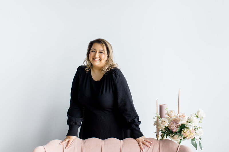 Jessie Khaira event planner looking into a white book