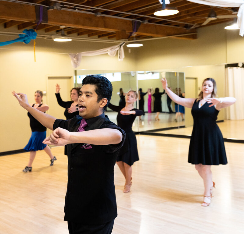 Dance students learning ballroom dancing from instructor at Dancers Studio.
