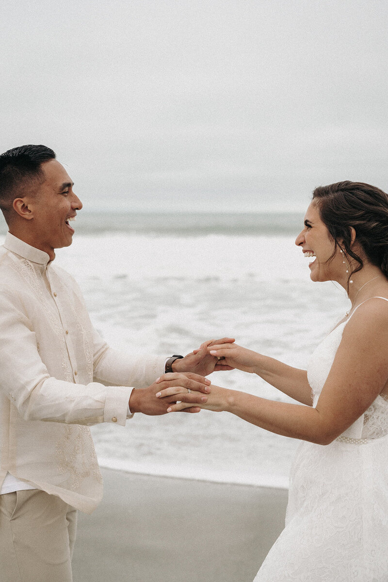 happy couple holding hands on the beach wedding