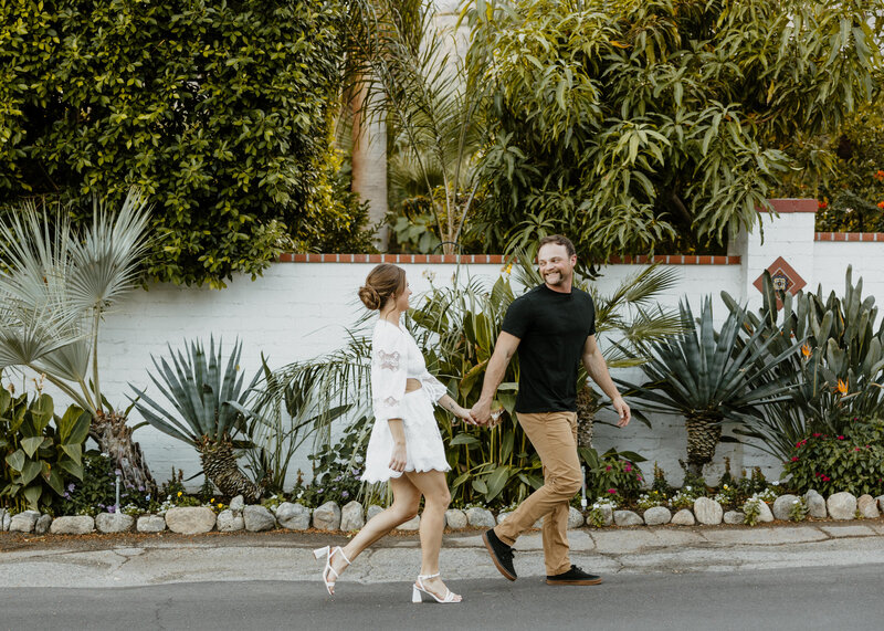 couple walking in street of palm springs villas