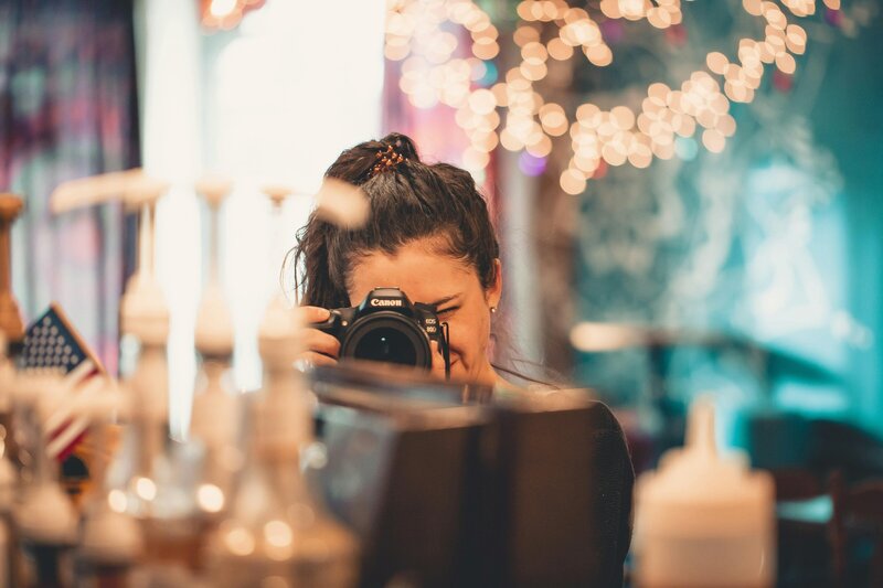 Wedding photographer taking details shots of the wedding reception venue.