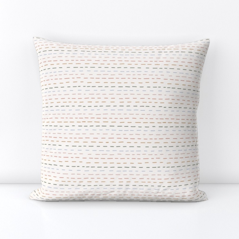 pillow with a pattern of multicolored dashed lines used as stripes, perfect with neutral decor, beach themes, feminine spaces, kids room...