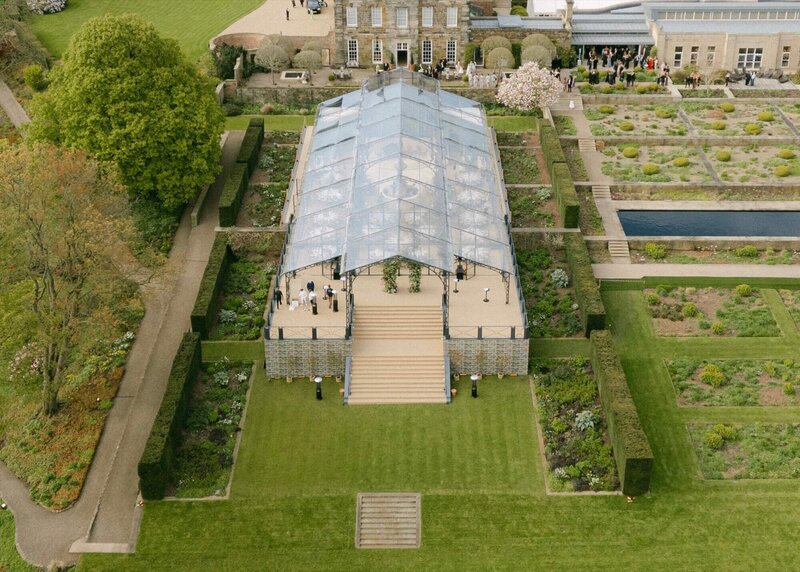 A large frame marquee with 60% of it having a clear roof.