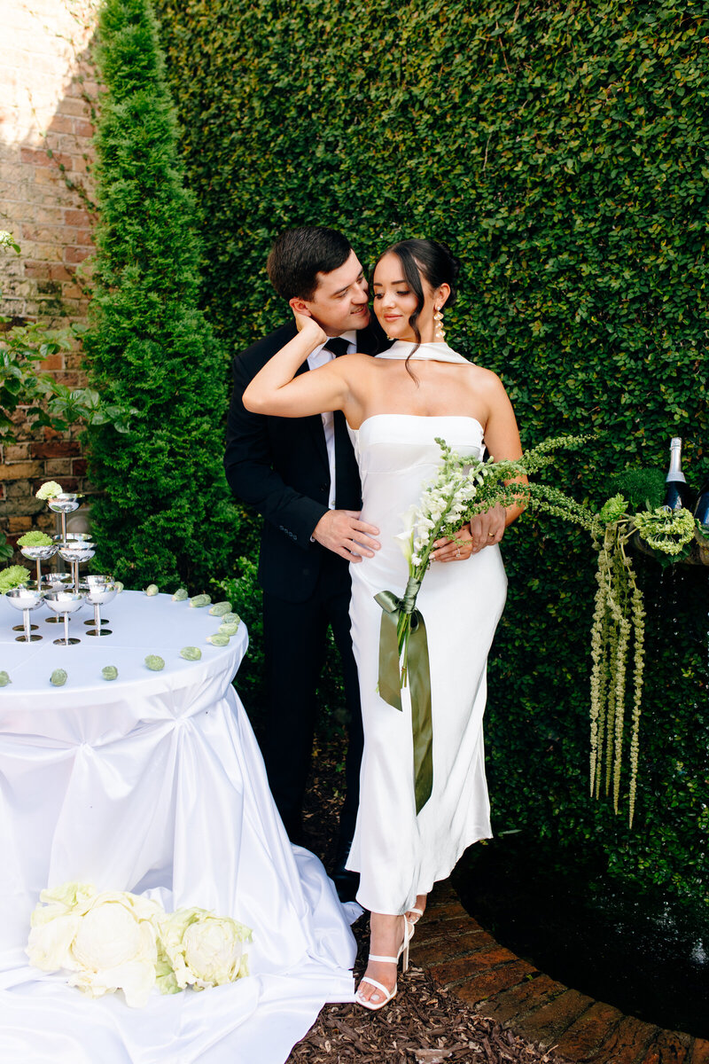 A bride and groom together on a rooptop.