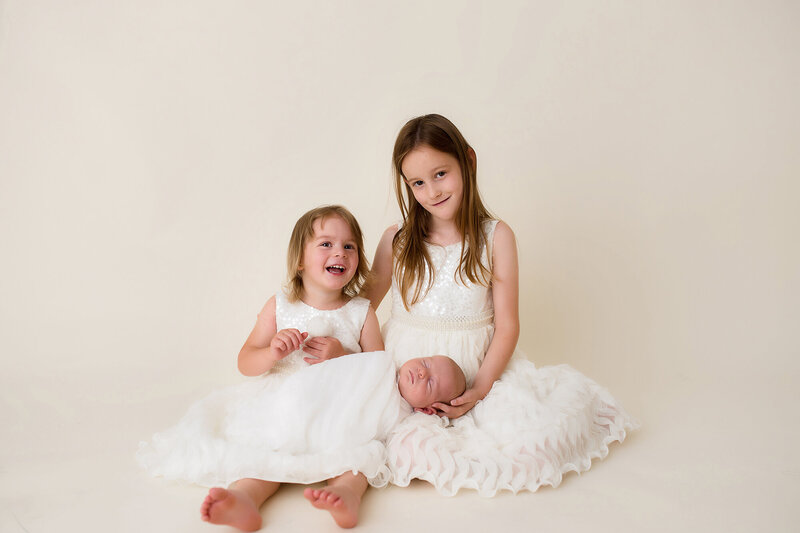 Family poses together during Maternity Photoshoot in Charleston, SC.