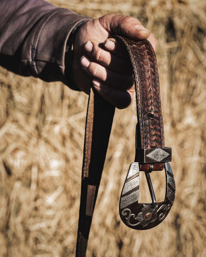 Man Holding A Leather Belt, Photo From The Lore Of The Range Collection