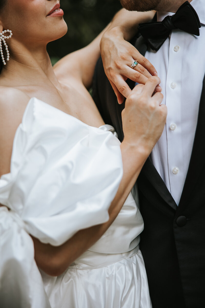 Mountain elopement photos with couple holding onto each other