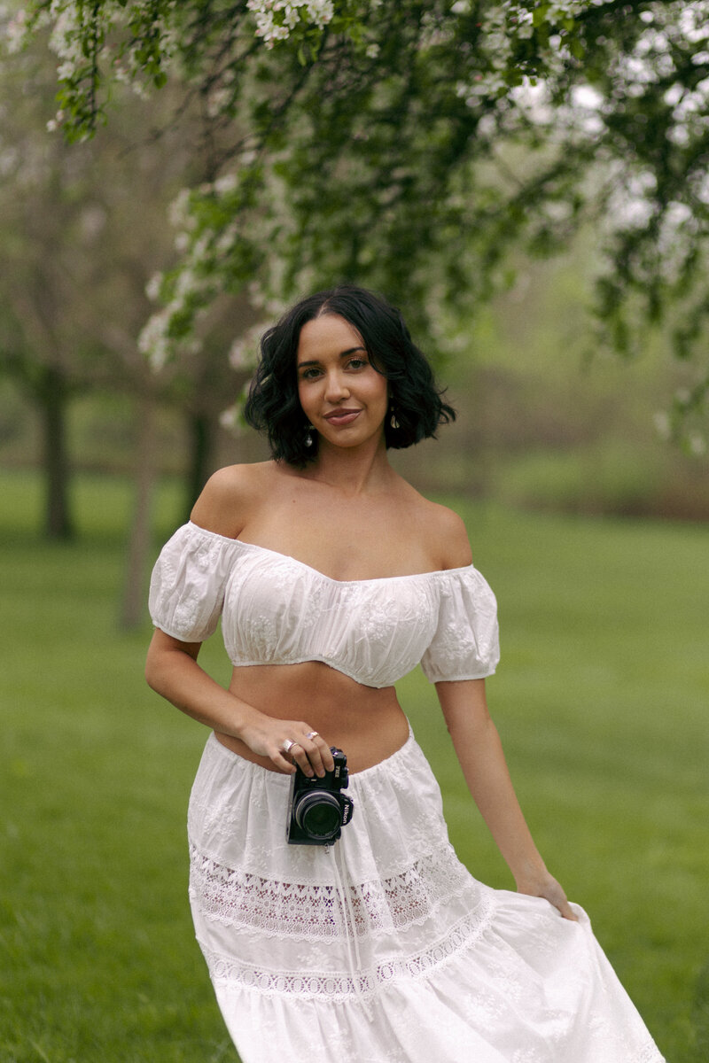 photographer smiling with a camera on her head