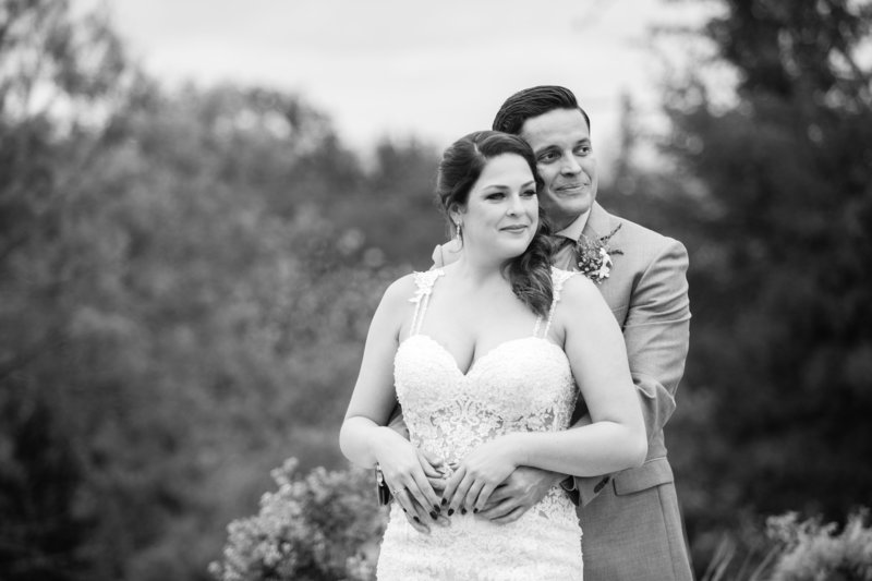 bride and groom hold each other black and white