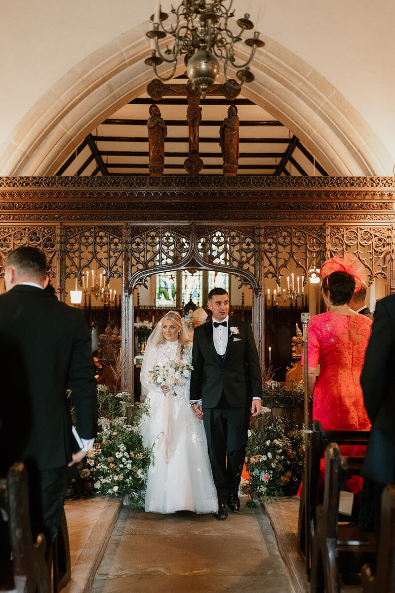 bride and dad walking down the aisle of the church at Sant frraed House