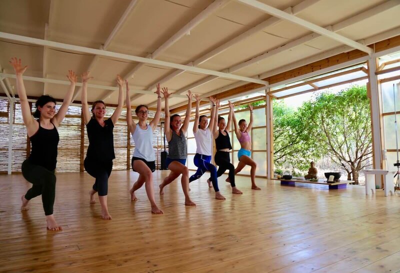 Students practicing synchronized lunging poses together.