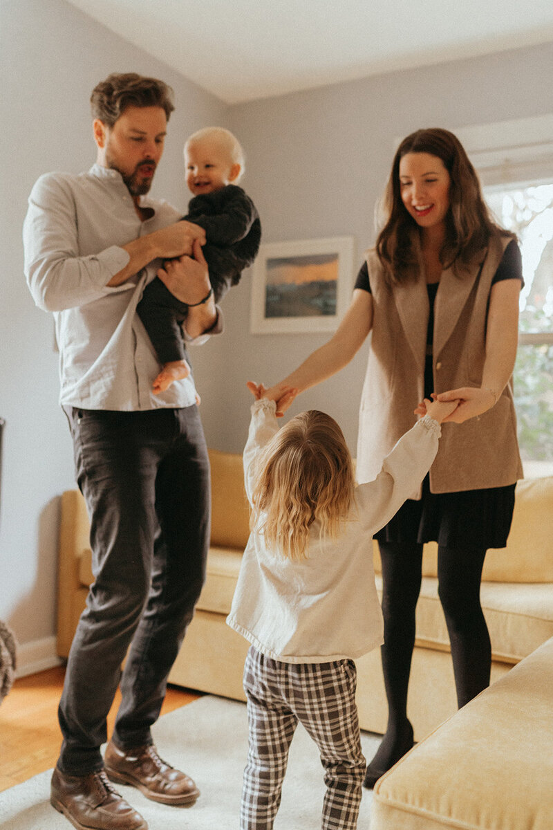 couple dancing with their kids captured during family photoshoot by Elsie Goodman Photography, an NYC family photographer