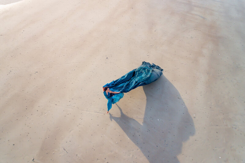 Savannah Georgia Boudoir and Glamour Woman in blue parachute gown on beach running drone picture