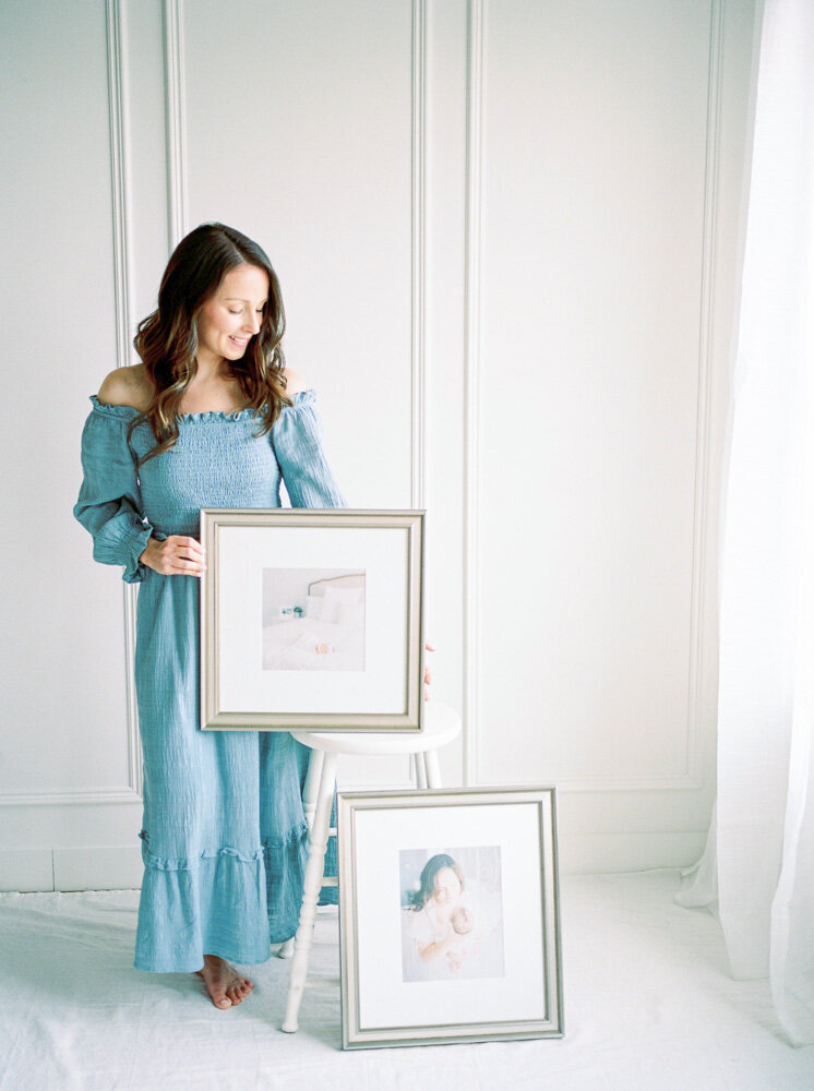 Edmonton Newborn Photographer Kahla Kristen Photography, holding up fine art framed prints