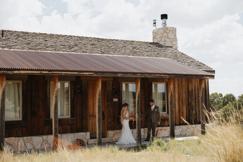 Couple seeing each other for the first time at their elopement venue, Zion Mountain Ranch cabins