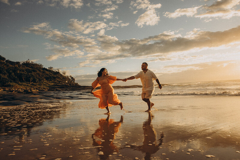 Warm cinematic photograph of an engagement and proposal at sunset on the beach on the Sunshine Coast