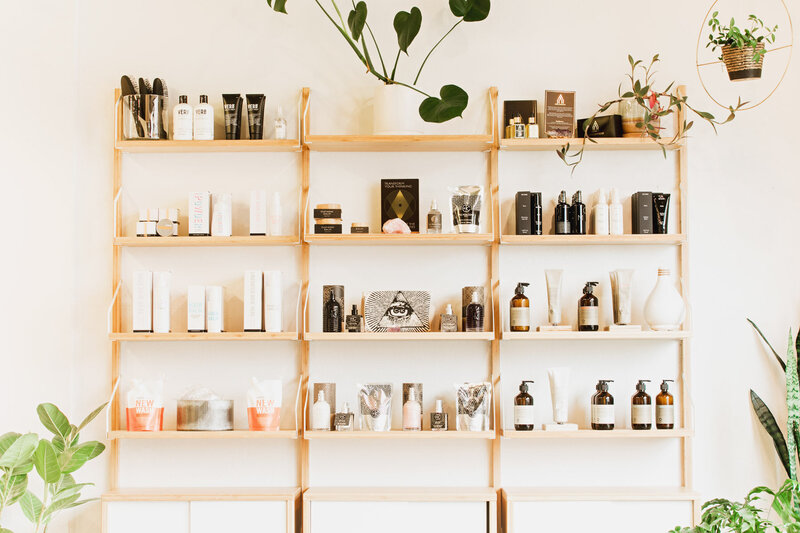 Wooden shelves with cruelty fee hair products used at The Collective Beauty and Wellness.