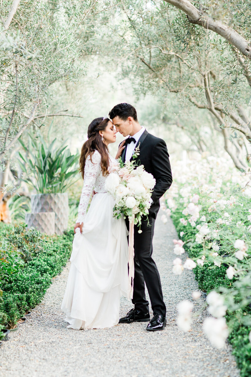 An intimate wedding surrounded by lush florals, candlelit pathways, and timeless elegance.