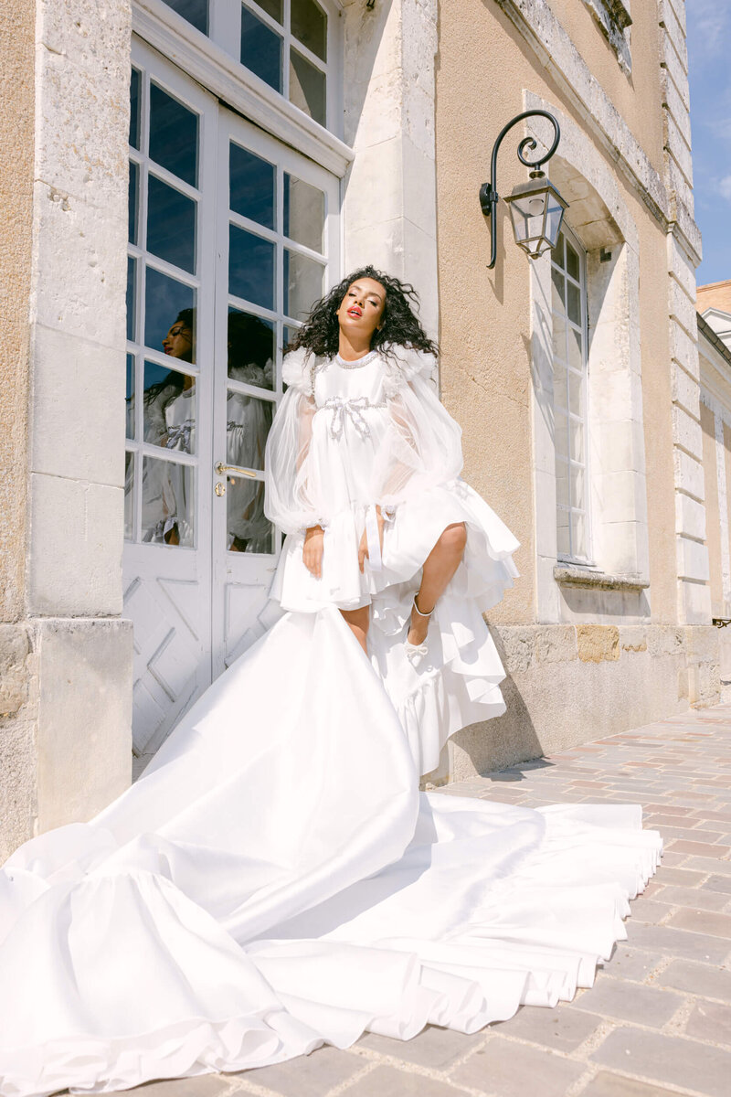 Bride posing for a photo in the gardens of chateau du grand luce during her wedding