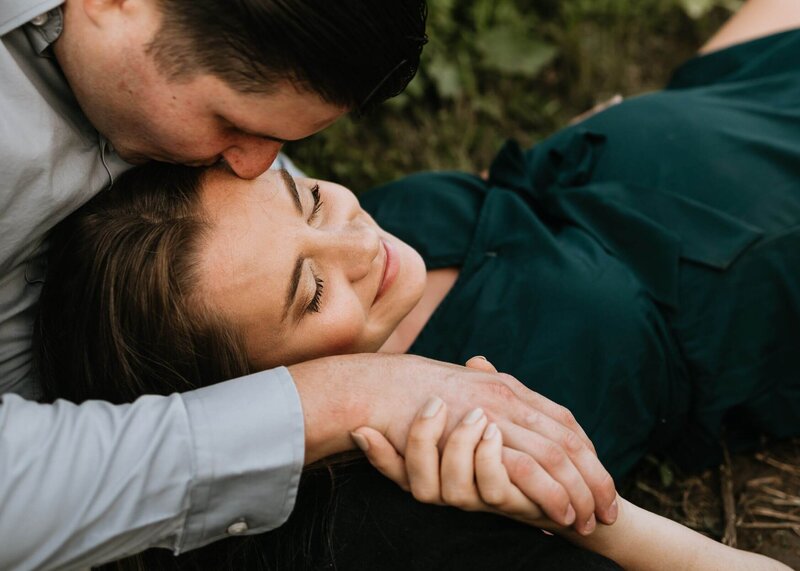 Pittsburgh maternity photographer captures couple laying on the ground during session.
