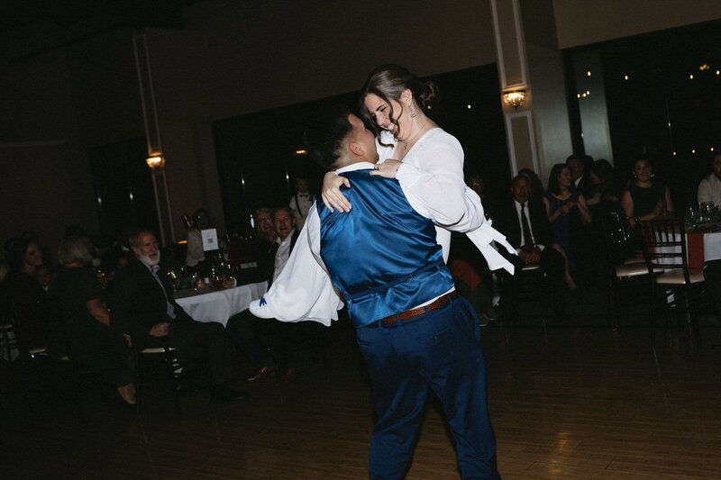 A moment in the bride and groom's first dance where he holds her in his arms and spins.
