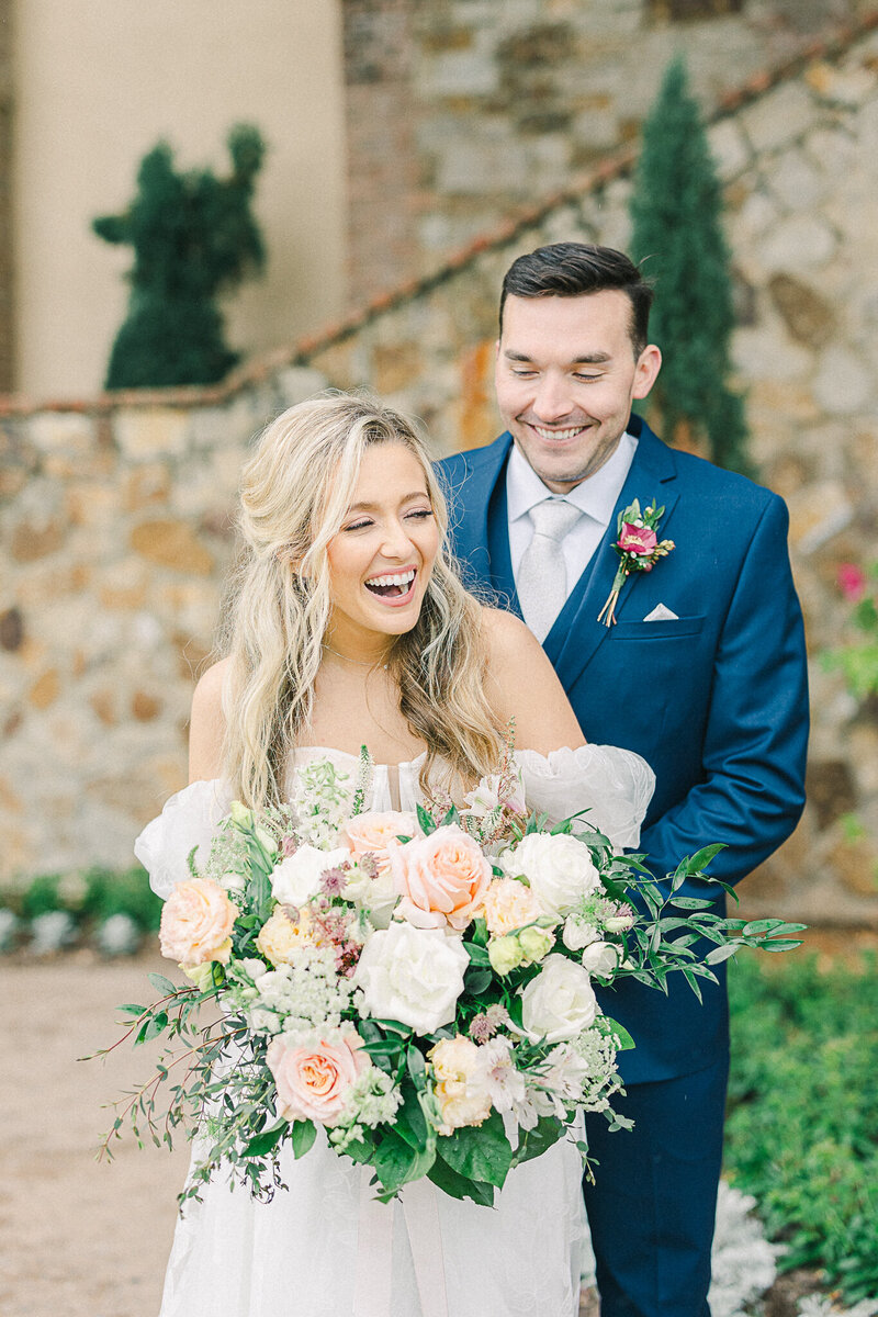 Elegant wedding ceremony at Bella Collina in Montverde, Florida, featuring a bride and groom surrounded by Tuscan-inspired architecture, lush gardens, rolling hills, and picturesque lake views.
