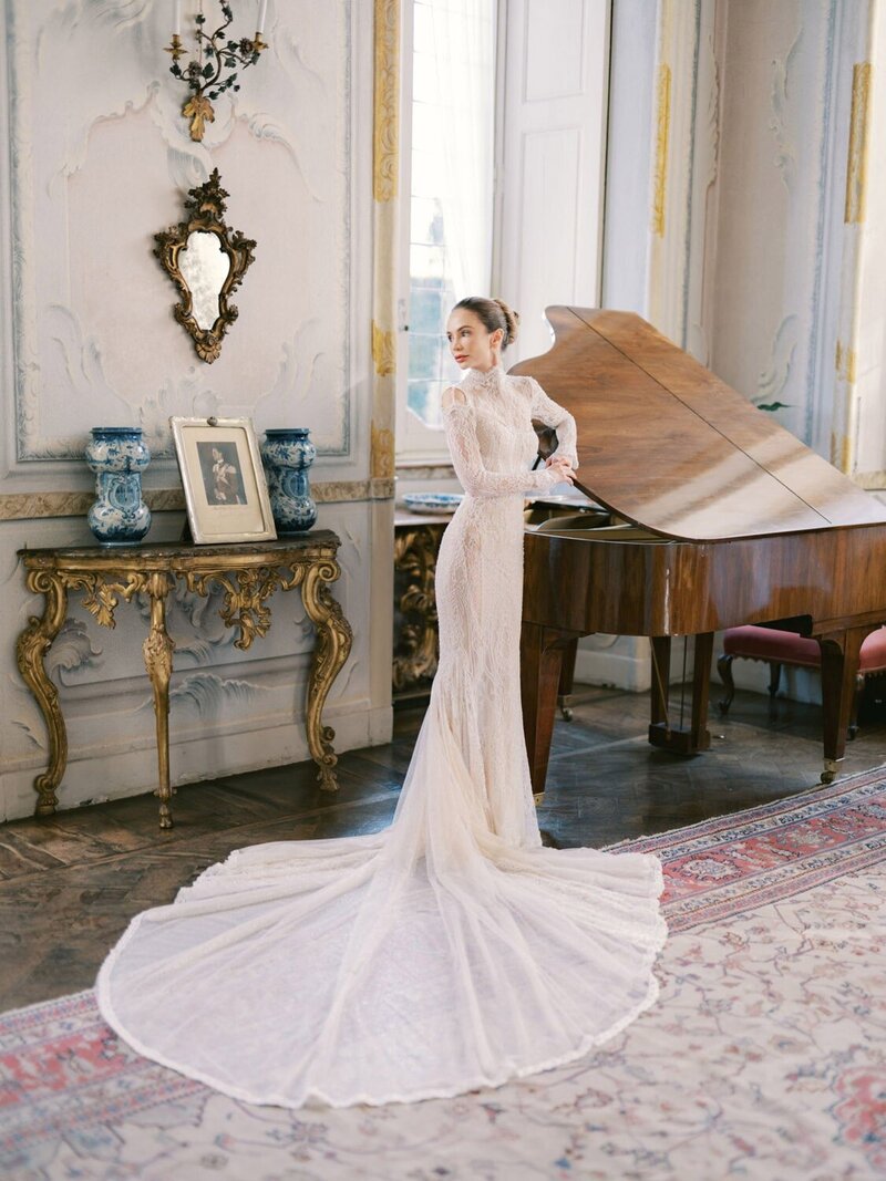 Bride during her villa Sola Cabiati wedding, standing by the piano and wearing a Galia Lahav wedding dress, by Lake Como Wedding Photographer Andreas K. Georgiou