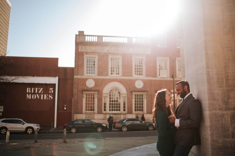 Couple embracing each other in old city Philadelphia during their engagement session.